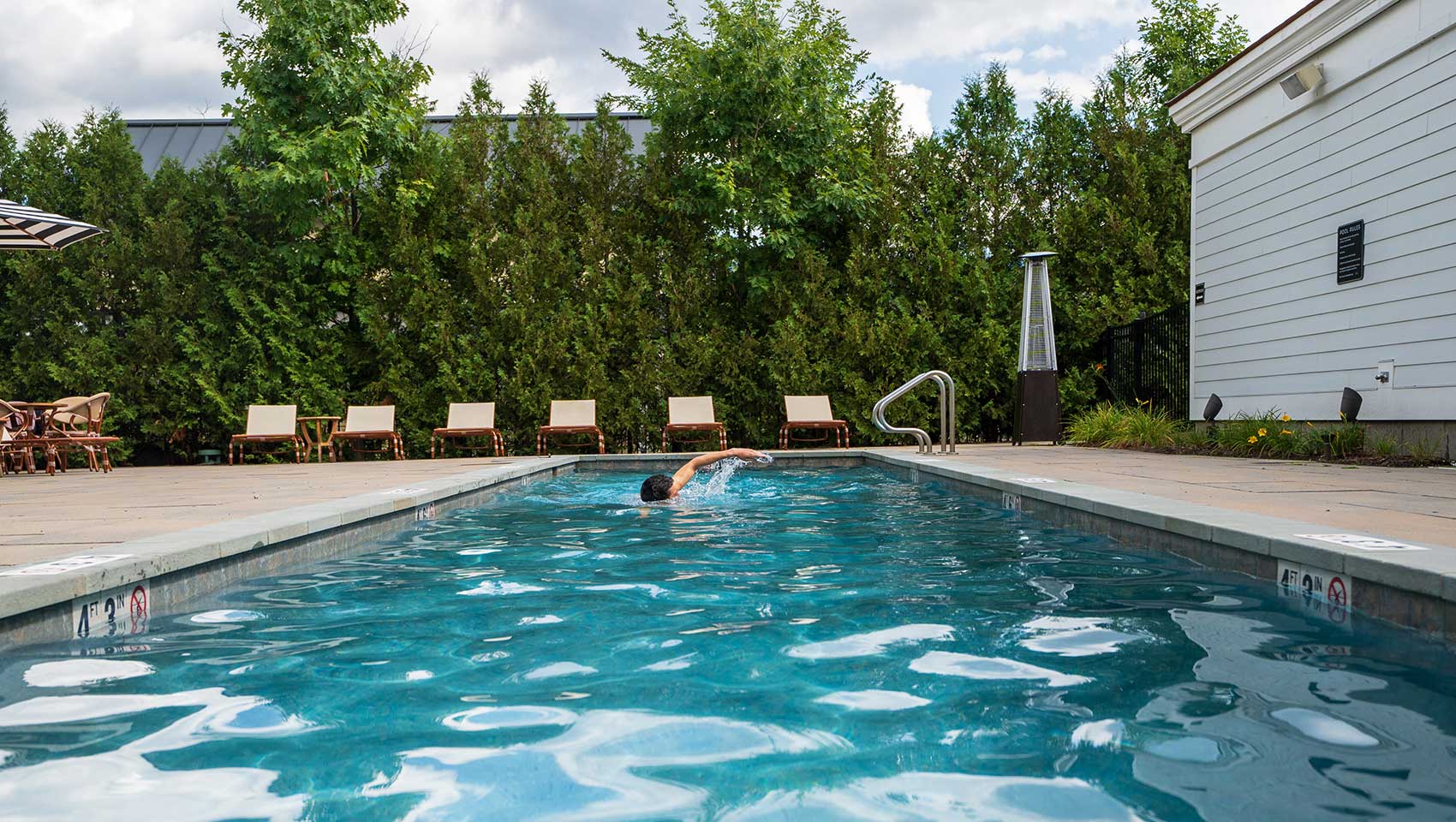 Man swimming in Kimpton Taconic Pool