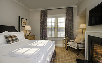 guestroom with fireplace and window